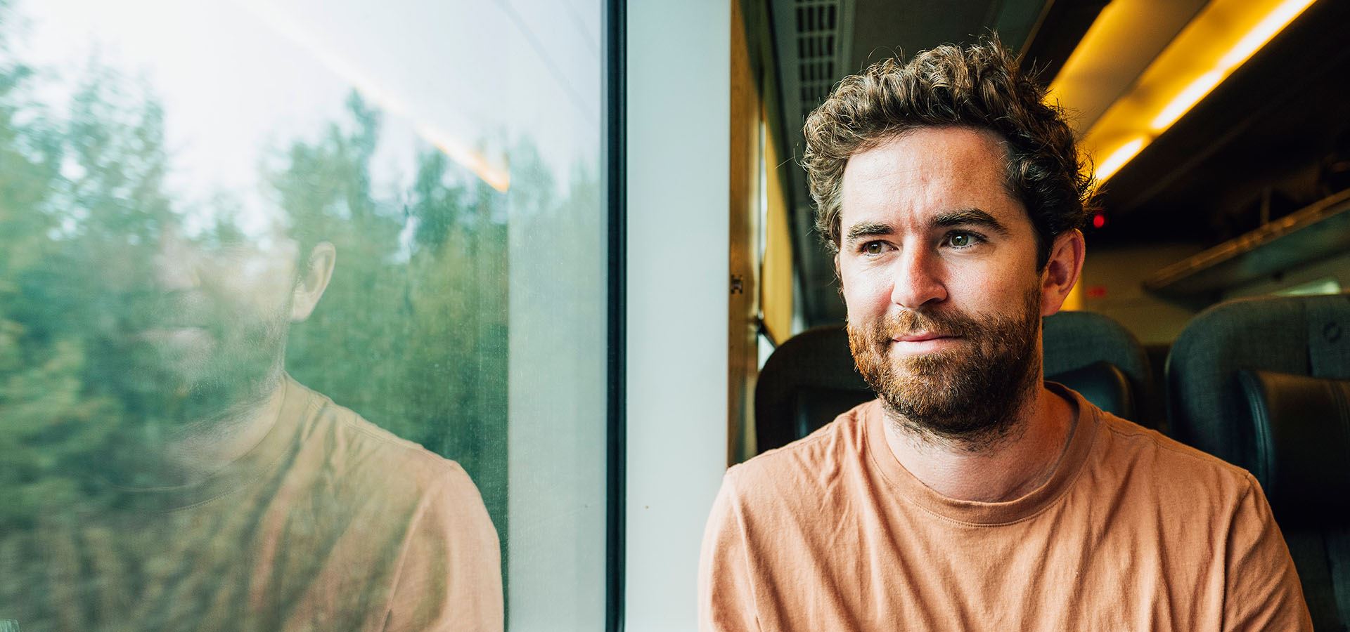 Fem personer väntar på bussen vid en busshållplats.